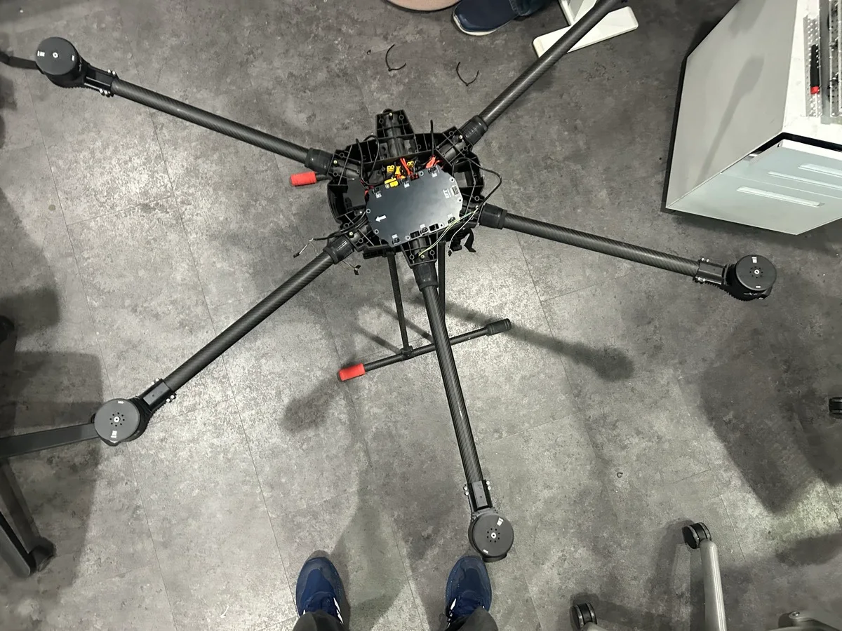 The six-arm drone airframe in the BatLabs workshop, viewed from above, with motors and no propellers.